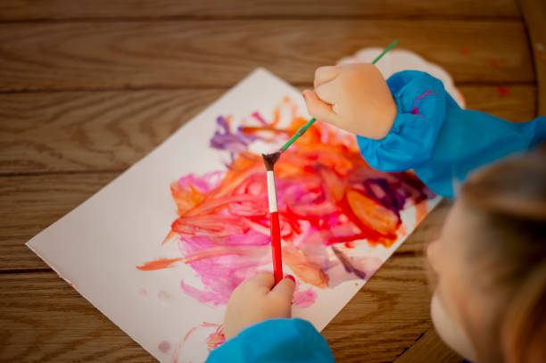 istock Child Painting with Washable Paint and Brushes 1389783356