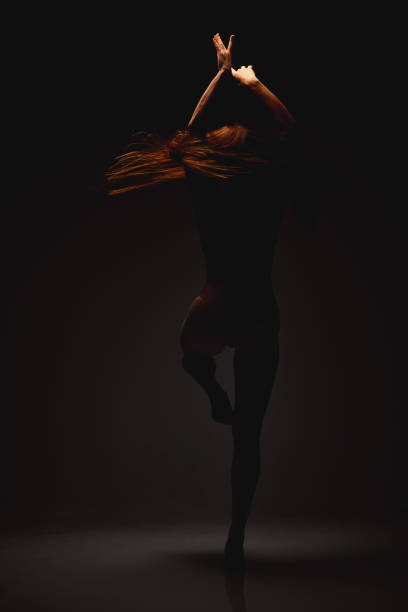 istock Shot of a performer dancing against a dark background 1389783403