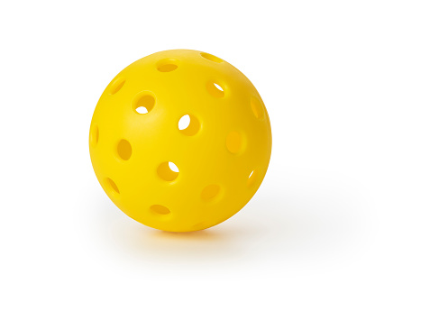 This is a photograph taken in the studio of a pickleball ball Isolated on a White Background
