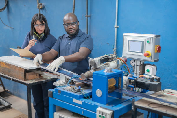 istock Multiracial workers operating machinery at solar panel factory 1389793659