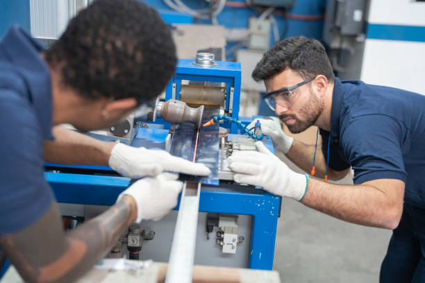istock Multiracial workers operating machinery at solar panel factory 1389793662
