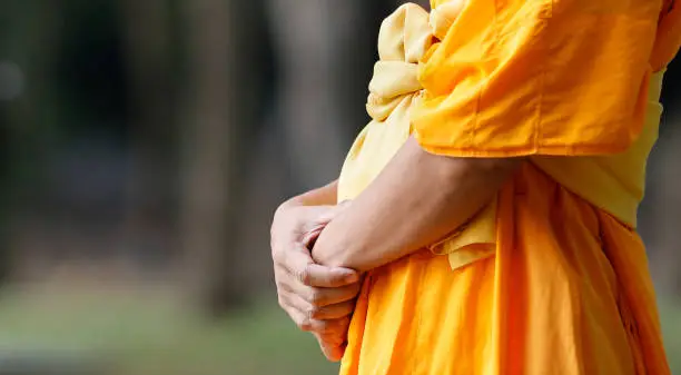 Close up of Buddhist Thai monk meditation with inner peace that lead to enlighten wisdom and life balance for Buddhism religion and belief