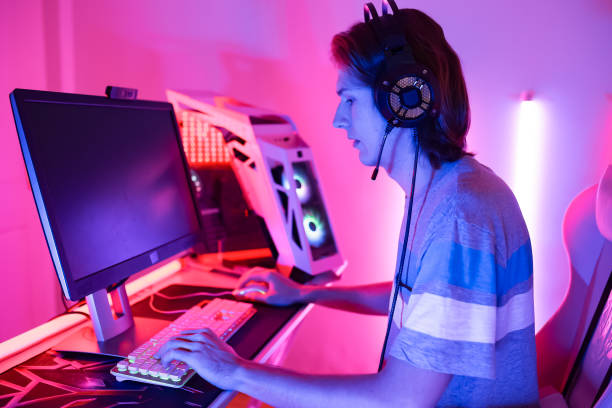 istock Young  man is using virtual reality headset. Neon light studio portrait. Concept of virtual reality, simulation, gaming and future technology play game in living room. 1389795949
