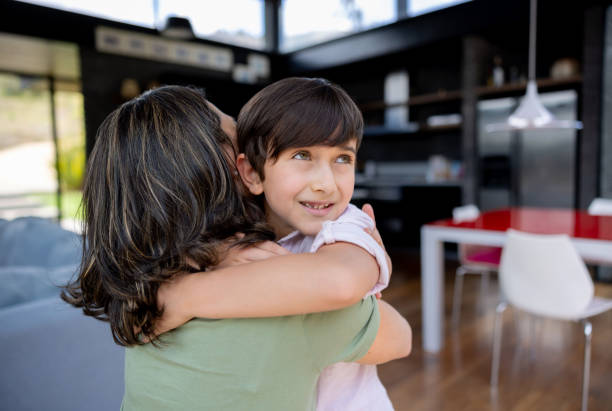 istock Loving son hugging his mother at home 1389796718