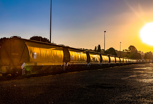 A row of train carriages at sunset in Australia.