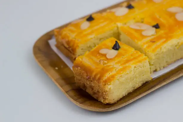 Lekkker Holland cake served with slices. The cake's real name is Dutch Buttercake or Boterkoek.
