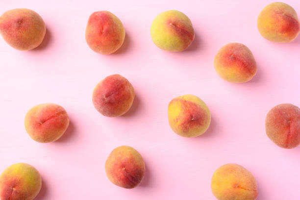 Peach fruit on pink background, Flat lay
