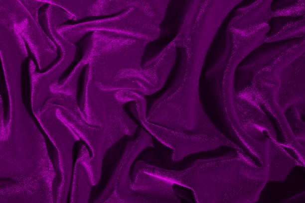 istock Texture of lilac bright velvet folded in gentle waves. 1389800772