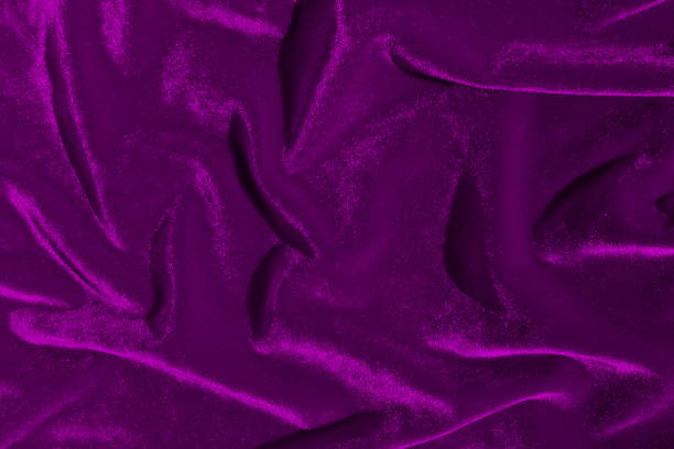 istock Texture of lilac bright velvet folded in gentle waves. 1389800877