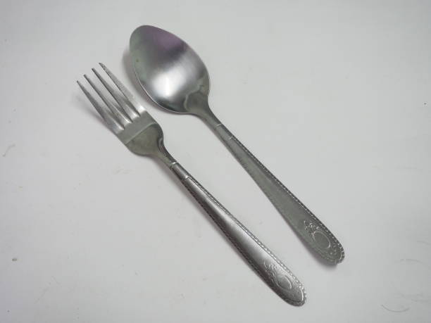 istock Carrying a pile of silver fixings on a white background. 1389803813