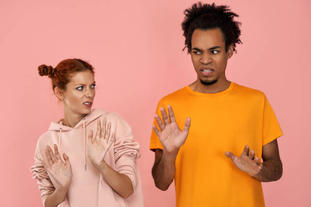 istock Displeased ginger girlfriend and dark skinned boyfriend make refusal gesture, feel aversion 1389806610