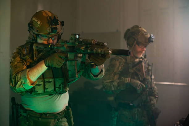 istock Focused young soldier with machinegun 1389807530