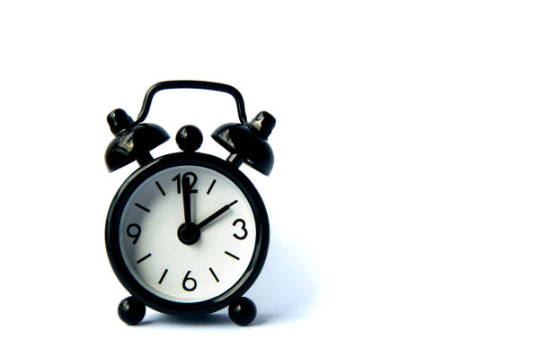 istock Black alarm clock isolated on white background. The clock set at 10 o'clock. 1389815246