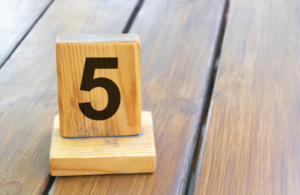 Wooden priority number 5 on a plank tab.