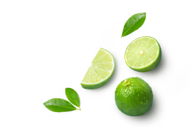 istock Lime fruits with green leaf and cut in half slice isolated on white background. 1389816278