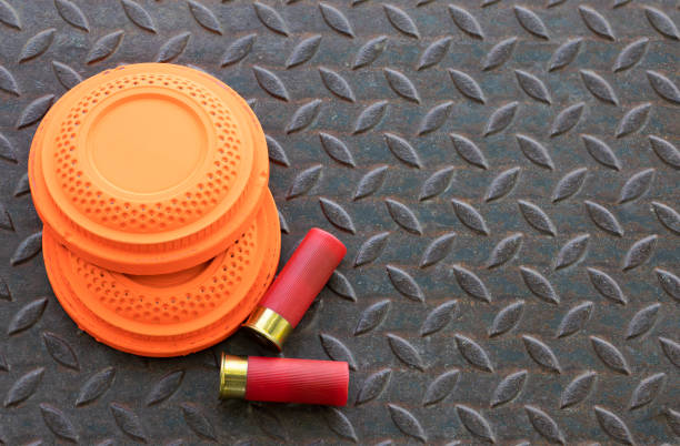 istock Clay shooting target with shotgun bullet on checkered plate background , gun shooting game 1389816318