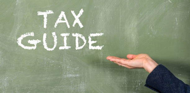 istock TAX GUIDE. Text on a green chalkboard 1389820664