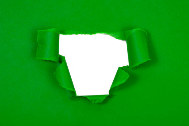 istock Green crushed torn paper with hole copyspace background for idea 1389823219
