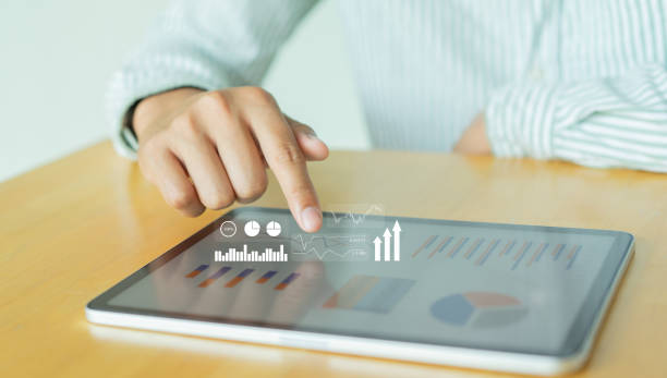 istock close up on businessman point at virtual dashboard statistic chart on digital tablet screen in office room to planning or analyzing the company's profit or business strategy for future technology concept 1389826588