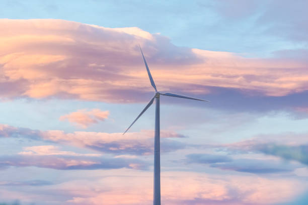 istock Model miniature wind turbine against the sunrise sky 1389826859