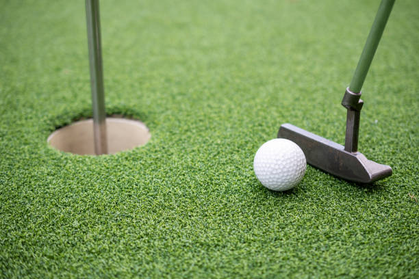 istock Golf ball and golf club on artificial grass. 1389829070