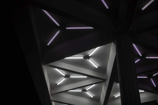 istock Light design. Fluorescent lamps on ceiling. Triangles of lamps. Interior details. 1389830683