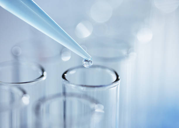 istock Shot of an unknown person inserting sample fluid into test tubes 1389831523