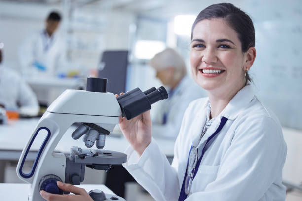 istock Shot of a young female lab tech using her microscope 1389831638