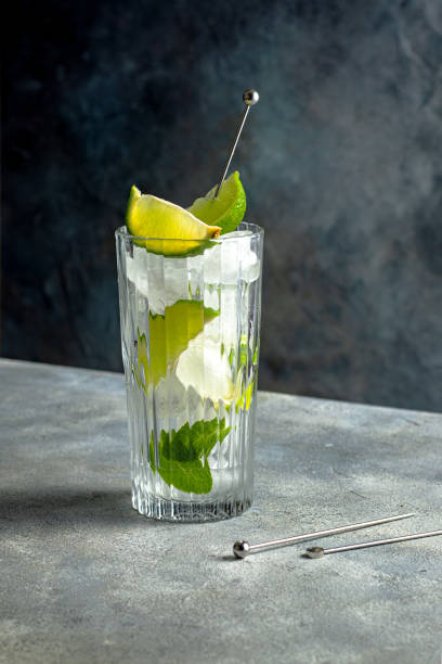 istock cocktail preparation. glass with lime, ice cubes, mint 1389831688