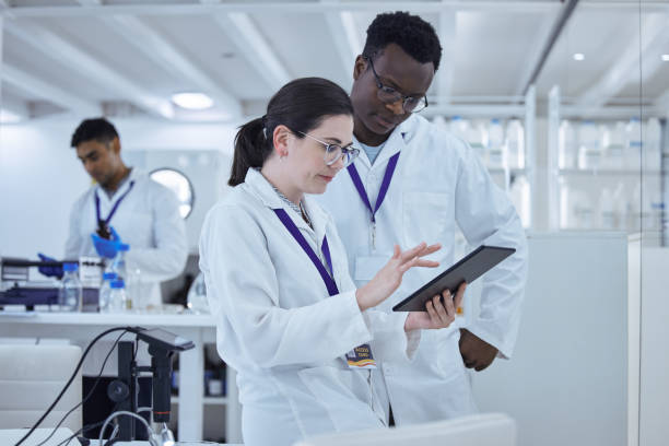 istock Shot of two colleagues working together on a scientific project using a digital tablet 1389831861
