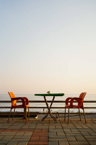 Two chairs and table on seaside line terrace
