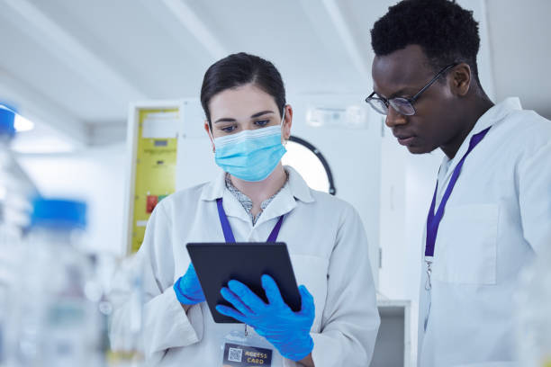 istock Shot of two colleagues working together on a scientific project using a digital tablet 1389835032