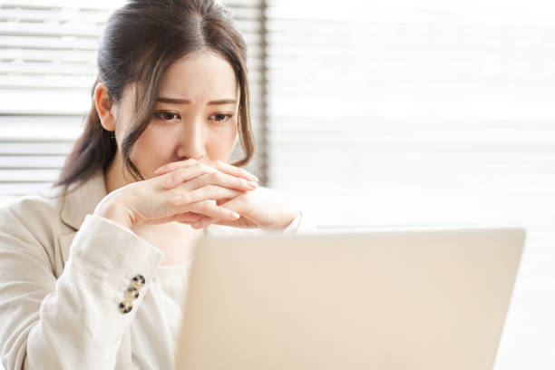 Asian woman thinking in trouble stock photo