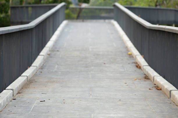 istock Background image of elevated walkway bridge with black anti-fall fence 1389836622