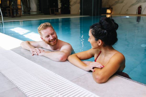 istock Couple Relaxing In The Swimming Pool 1389838485