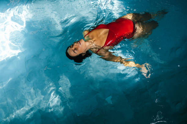 istock Brunette Woman In The Swimming Pool 1389838520