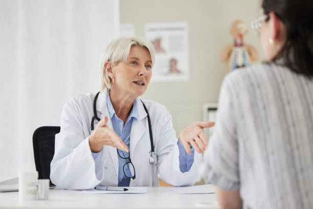 Shot of a mature doctor having a consultation with a patient I'd like to hear your ideas general practitioner stock pictures, royalty-free photos & images