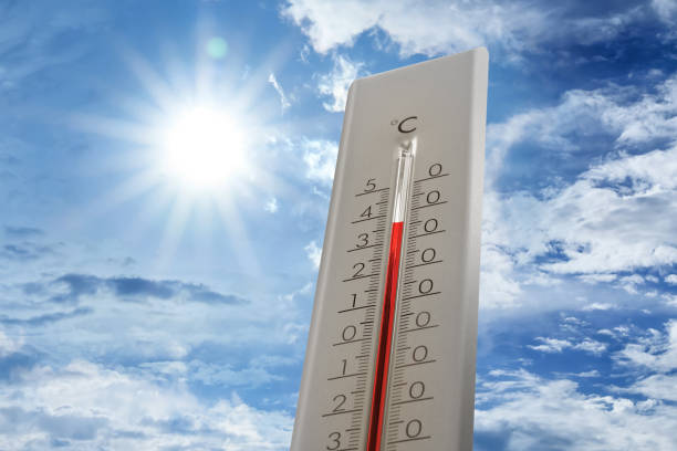 istock Weather thermometer showing high temperature and blue sky with clouds on background 1389842773
