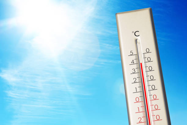 istock Weather thermometer showing high temperature and blue sky on background 1389842786