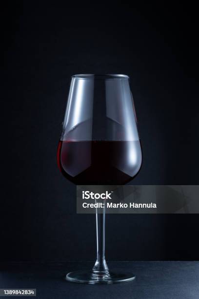 Closeup Of A Red Wine Glass Against A Dark Background Stock Photo - Download Image Now