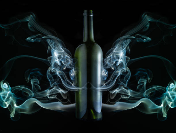 Concept of green wine bottle in the middle of a smoke installation stock photo