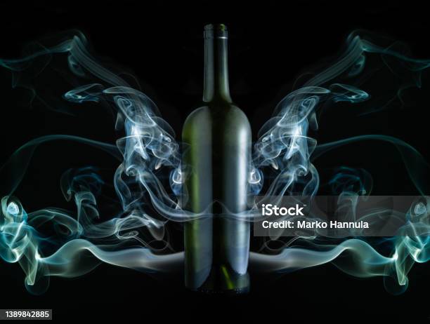 Concept Of Green Wine Bottle In The Middle Of A Smoke Installation Stock Photo - Download Image Now