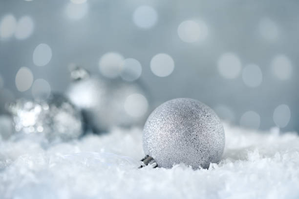 istock Beautiful silver Christmas ball on snow, bokeh effect 1389842893