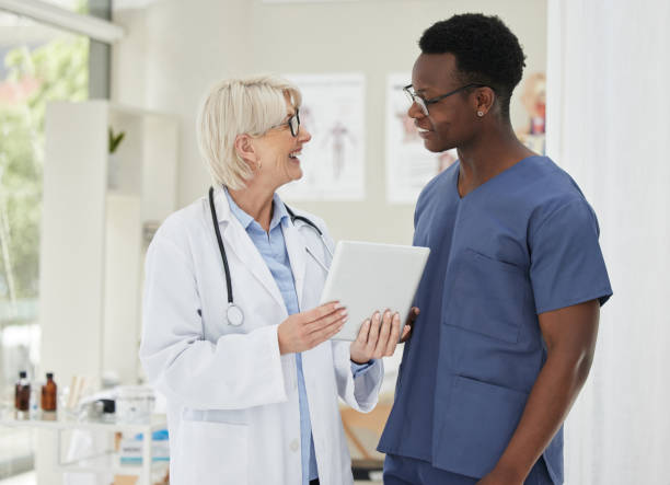 istock Shot of two medical doctors having a discussion while using a digital tablet 1389843760