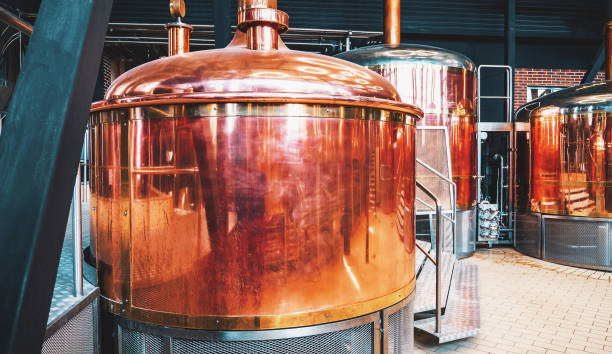 istock Brewery equipment. Brew manufacturing. Round cooper storage tanks for beer fermentation and maturation 1389844342