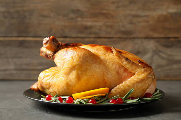 istock Delicious cooked turkey served with rosemary, oranges and cranberries on grey table. Thanksgiving Day celebration 1389844932