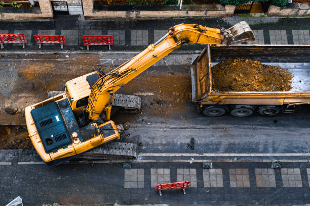 construction equipment excavates a city street
