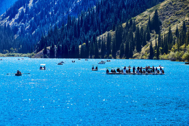 view of pleasure boats floating on the lake. Kolsay Lakes National Park, Kazakhstan