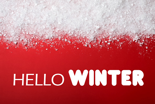 Greeting card. Snow near text Hello Winter on red background, top view