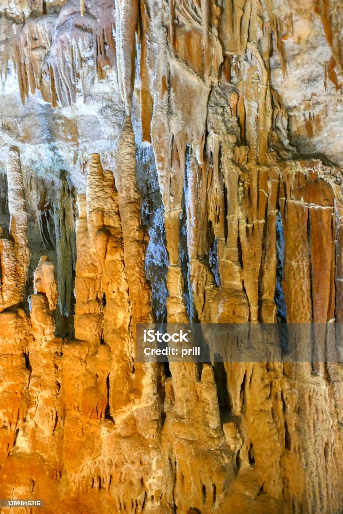 Flowstone cave Detail shot inside a flowstone cave in Apulia, Italy Stalactite Stock Photo